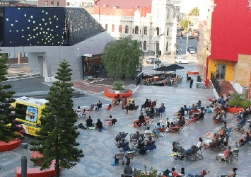 People in Harmony Square watching the Urban Screen
