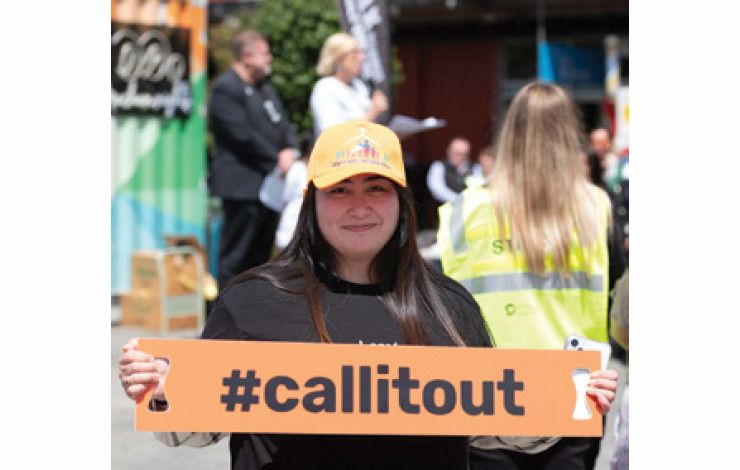 A lady holding a sign #callitout