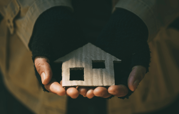 Close up of hands holding a crafted house