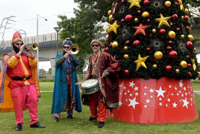 Three Musicians playing instruments in a park.