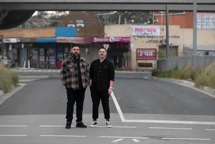 Artists Robert Michael Young and Koby Sainty standing in the middle of a road
