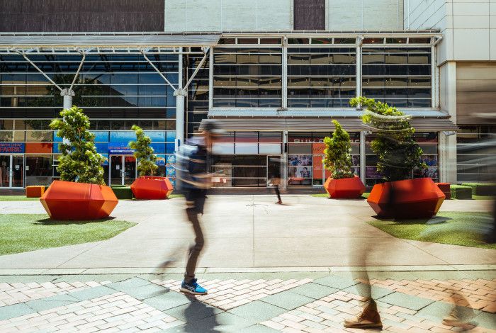 a person walking through an outdoor mall 