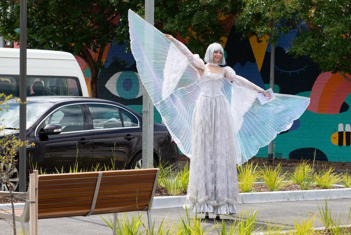 A performer with wings in her outfit