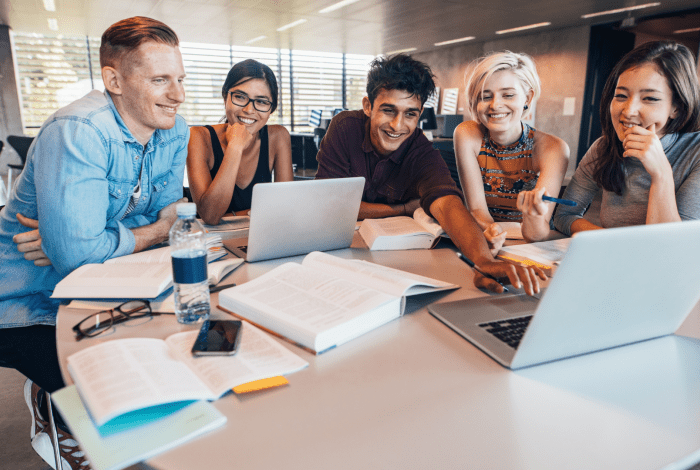 Students working together at a desk.