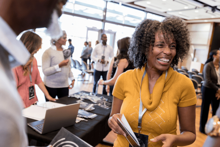 Person smiling at an expo