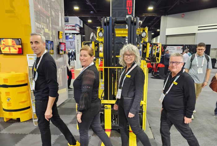 Four people smiling with equipment