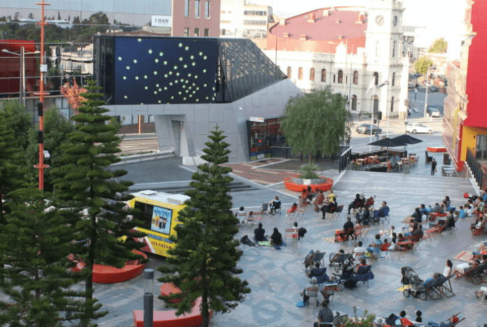 People watching the Urban Screen in Harmony Square
