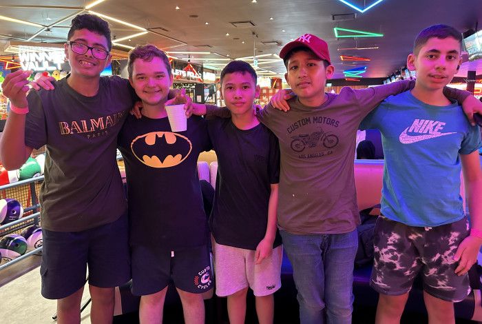 Group of young people smiling at bowling