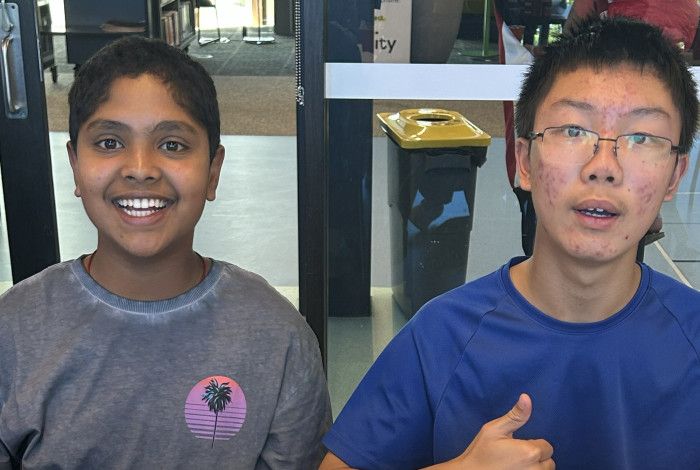 Young people smiling with artwork