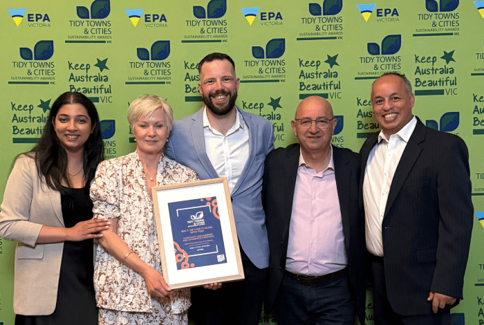 Waste team standing with award