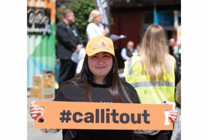 A lady holding a sign #callitout