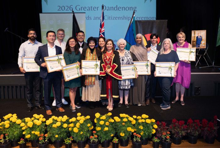 A large group of people all holding awards and smiling at the camera