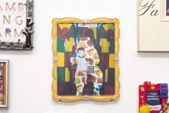 Variety of uniquely photo framed pictures on a wall.