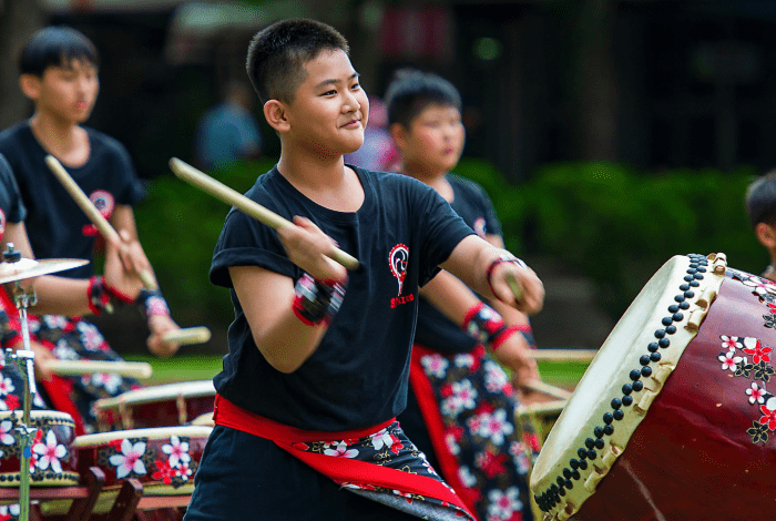 Five boys playing Taiko drums. 