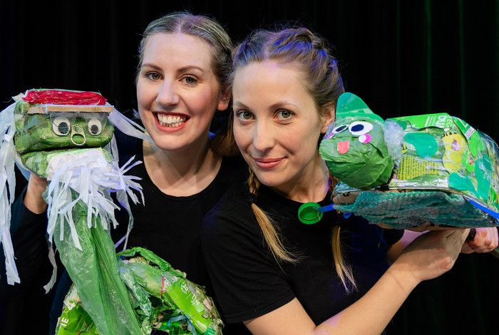Two ladies holding puppets
