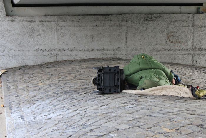 Someone sleeping on concrete