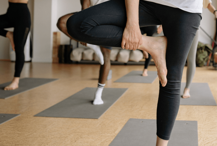 People yoga posing in a studio