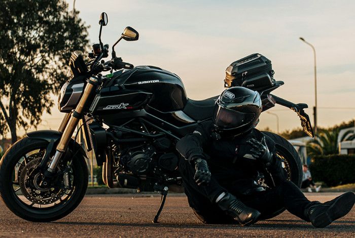 A motorcycle and a person sitting down