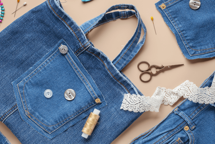 A denim tote displayed on the table with sewing paraphernalia.