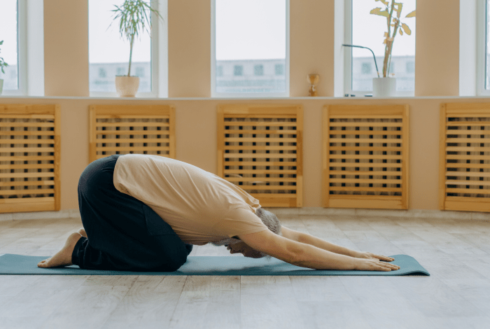 A man doing a yoga pose on the floor