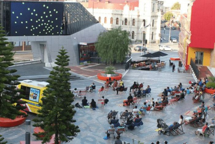People looking at the Urban Screen in Harmony Square