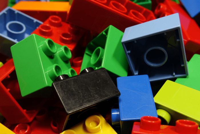 Colourful lego pieces that are broken up individually.