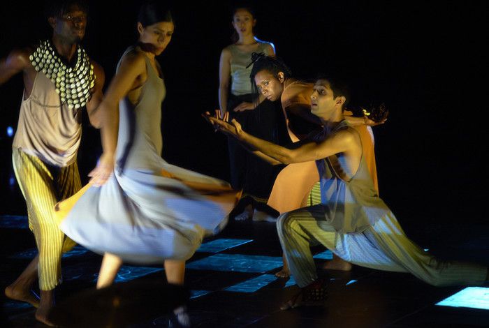People moving and performing on stage