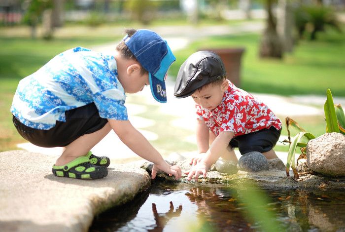Two children looking through the water