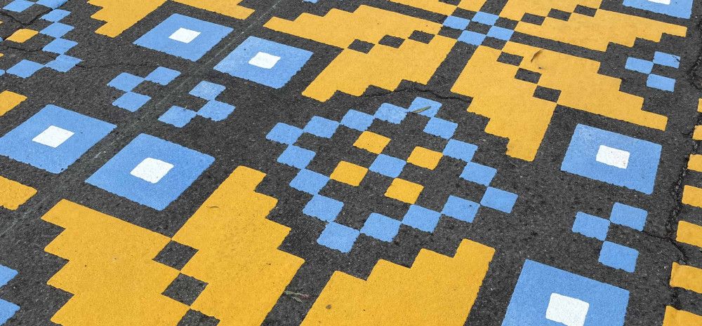 Blue and yellow stenciled mural.