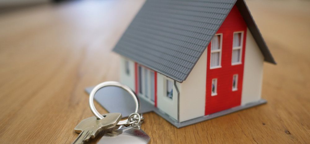 Small house and keys on a tabletop