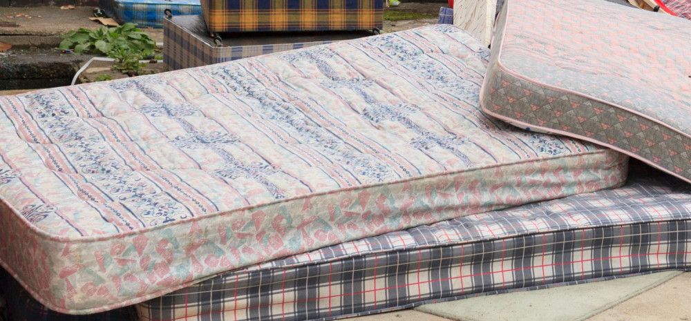 a pile of used mattresses