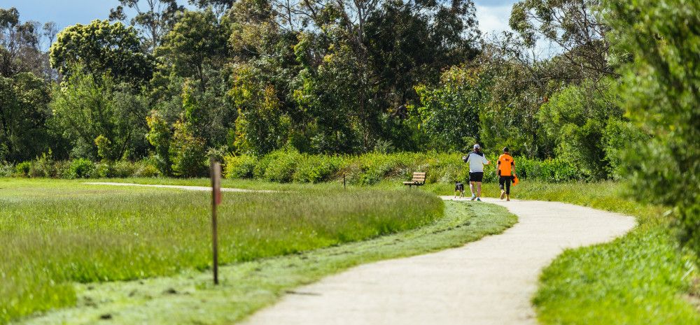 Two people walking on a track