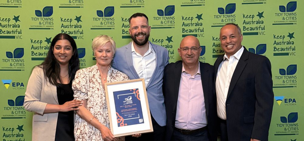 Waste team standing with award