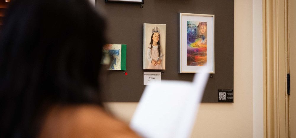 Person looking at 9 by 5 art on wall.