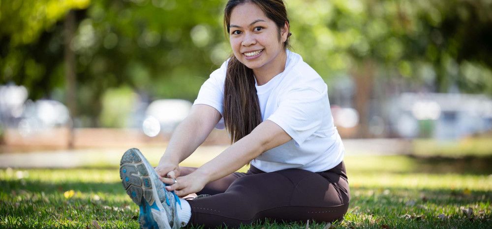 Councillor Melinda Yim exercising in a park