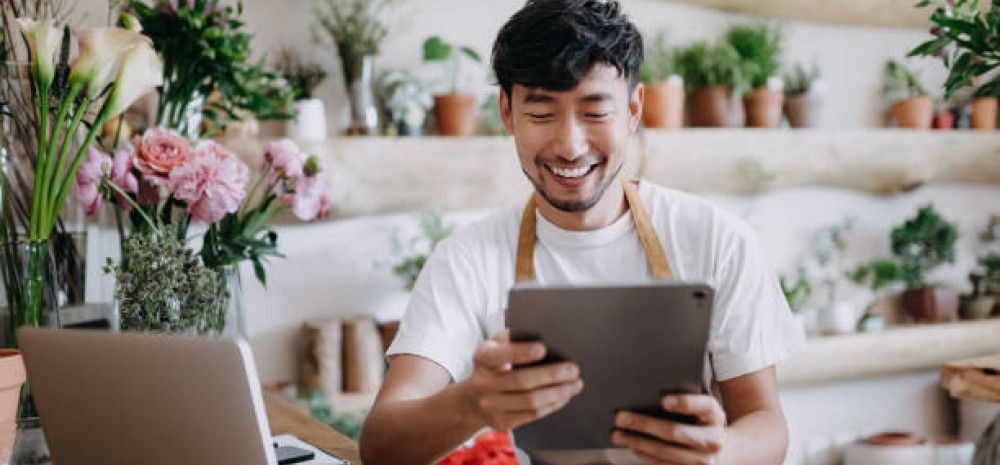 male business owner holding ipad