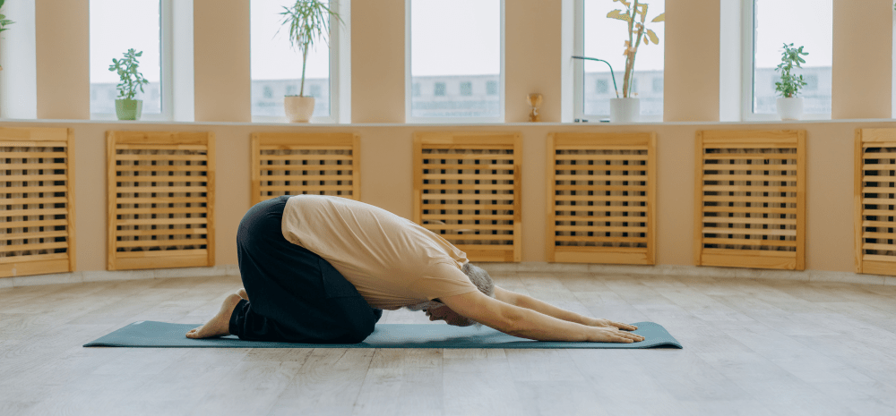 A man doing a yoga pose on the floor