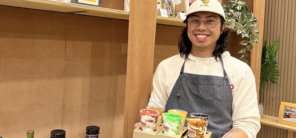 A man holding Yoghurts in plastic cups