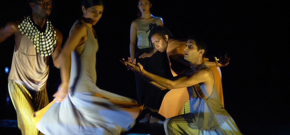 People moving and performing on stage