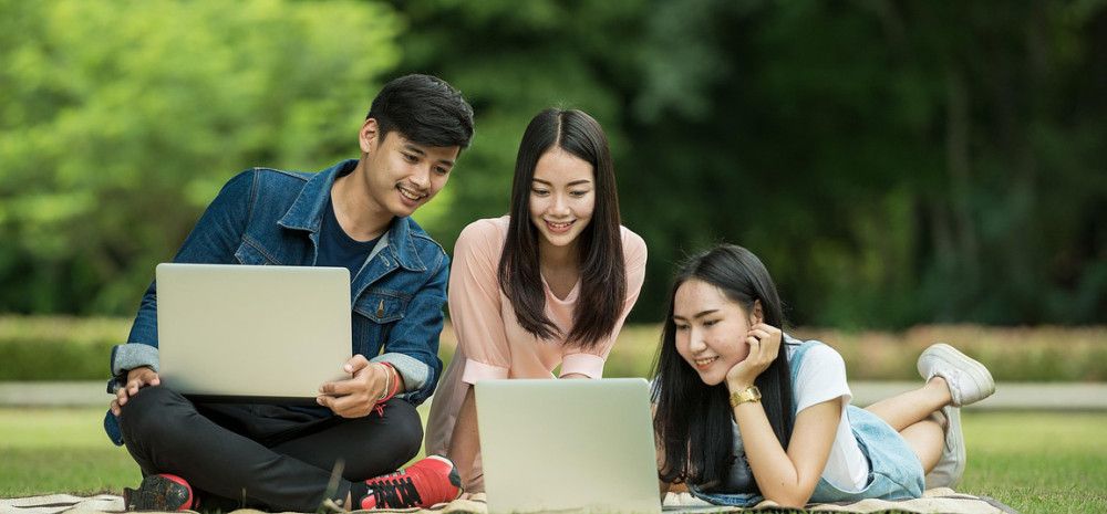 Young people looking at their laptops