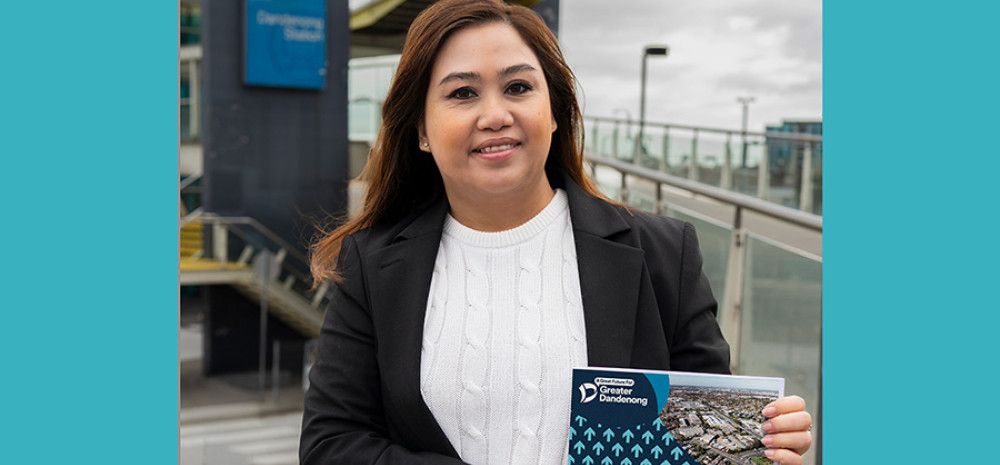 Councillor Sophie Tan holding a booklet A Great Future for Greater Dandenong