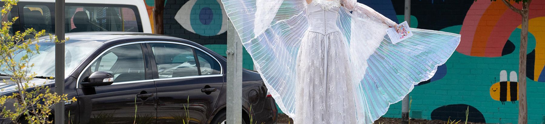A performer with wings in her outfit