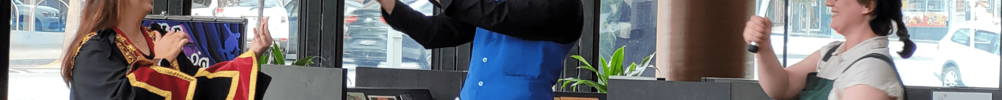 Mayor and Mr Marvel juggling in a library