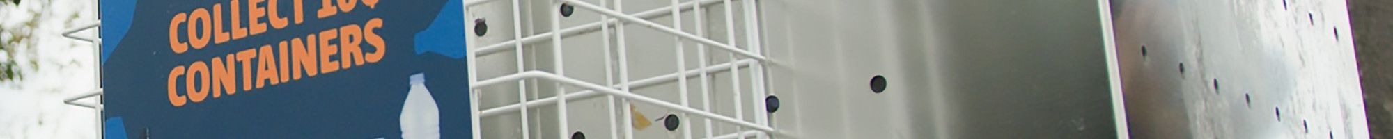 A small cage attached to the side of a stainless steel rubbish bin with a sign that reads “Leave or collect 10 cent containers”.