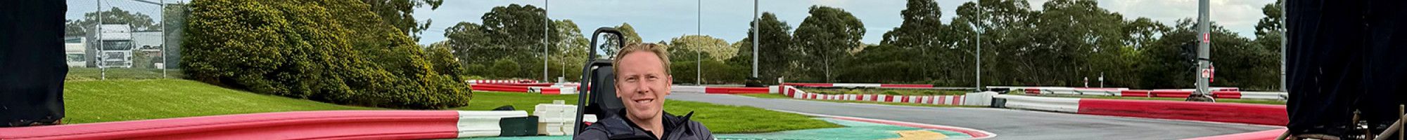 Someone riding a go kart