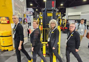 Four people smiling with equipment