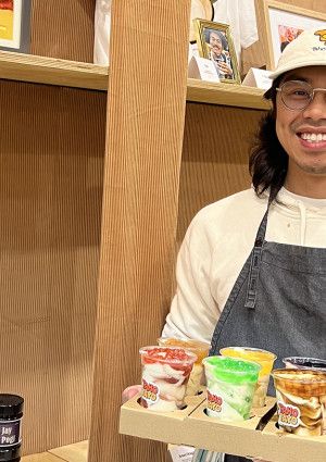 A man holding Yoghurts in plastic cups